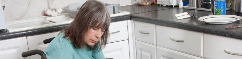 Woman in wheel chair in her kitchen